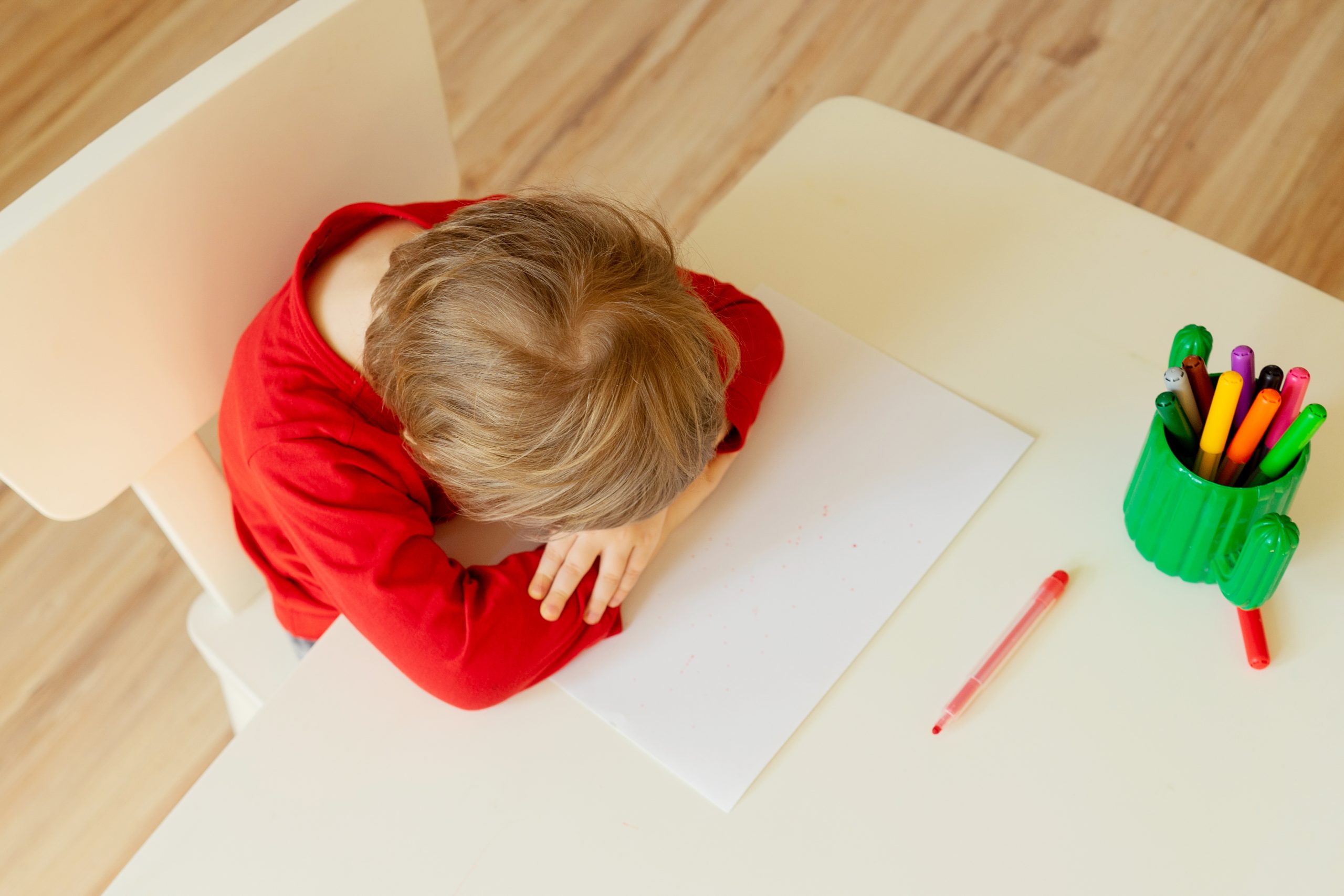 Boy tired to draw with felt pen